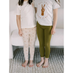 Two people in white t-shirts and Ditsy Rainbow Leggings by Polished Prints