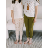 Two people in white t-shirts and Ditsy Rainbow Leggings by Polished Prints
