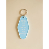 Light blue motel keychain with funny text about kissing your mother for daily laughs