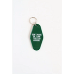 Green vintage hotel keychain with funny text Don’t Make Me Turn This Car Around