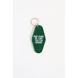 Green vintage hotel keychain with funny text Don’t Make Me Turn This Car Around