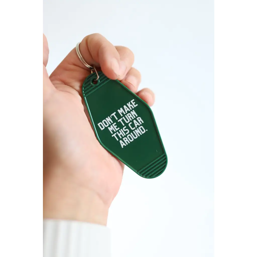 Green vintage hotel keychain tag with funny Don’t Make Me Look Around text