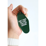 Green vintage hotel keychain tag with funny Don’t Make Me Turn This Car Around text