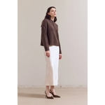 Brown textured Ellia henley sweater with white skirt and black heels