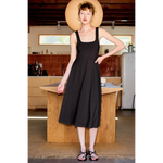 Woman in black Ellie Square Neck Fit and Flare Jersey Midi Dress made with stretchy jersey fabric