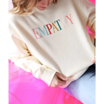Cream-colored Empathy Midweight Crewneck Sweatshirt with colorful lettering design