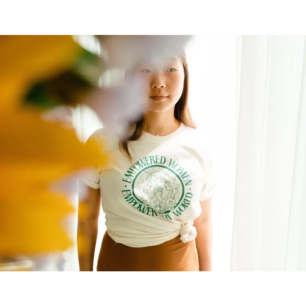 White t-shirt with a green graphic design promoting Empowered Women by Polished Prints