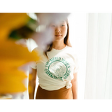 White t-shirt with a green graphic design promoting Empowered Women by Polished Prints
