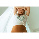 Person stretching with arms overhead in Empowered Women Empower the World T-shirt from Polished Prints