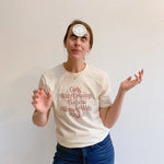 White t-shirt with pink text empowering women to dream and inspire with vision