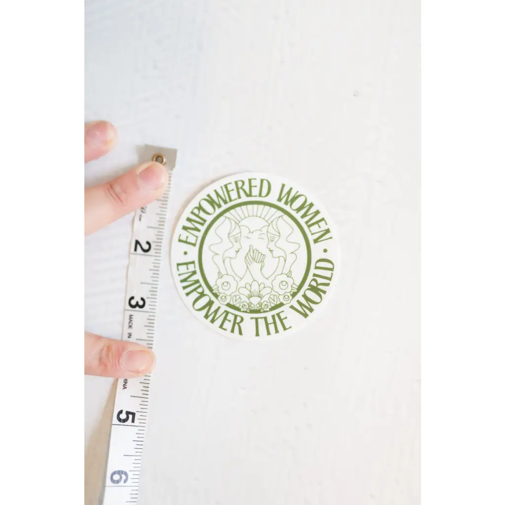 Circular green Empowered Women sticker with the message Empowered Women Empower The World