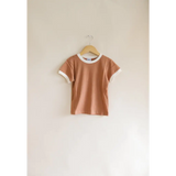 Peach Everyday Ringer Tee with White Trim hanging on a hanger for kids