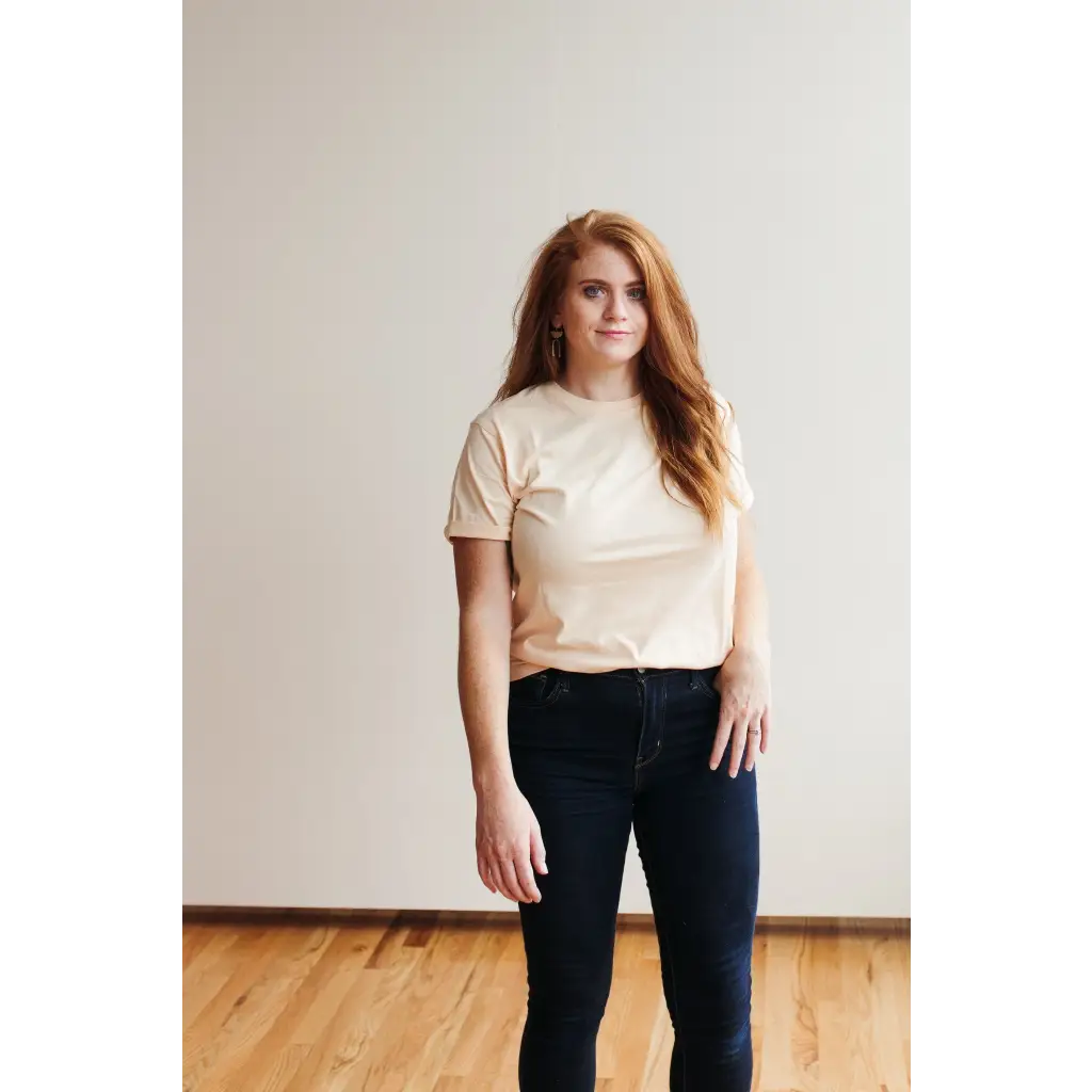 Person in cream Sunkiss Unisex Adult Tee, comfy organic cotton and dark jeans