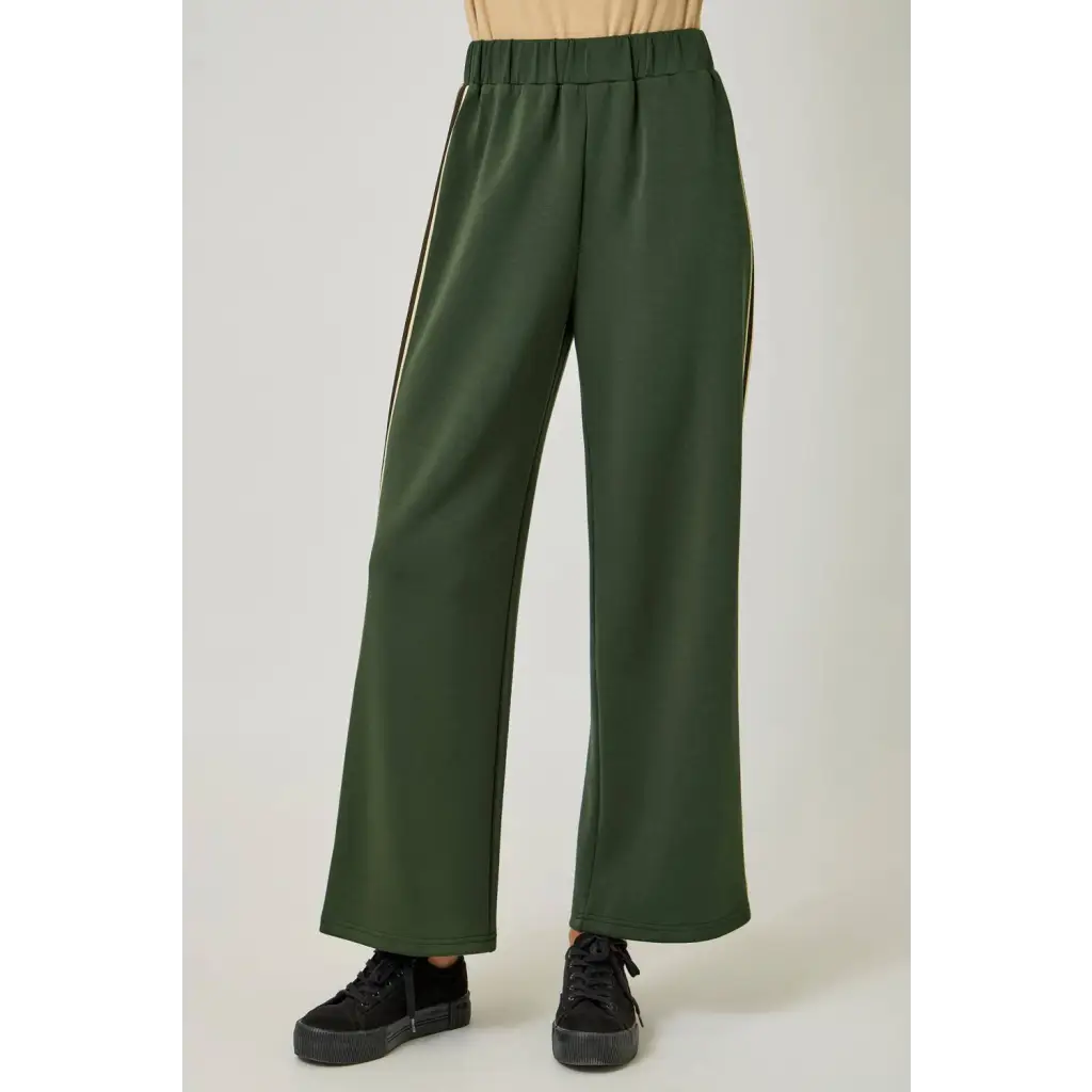 Olive green tracksuit pants with gold stripes and elastic waistband for stylish womens clothes