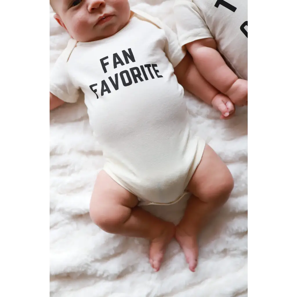 White baby onesie with FAN FAVORITE text, perfect go-to outfit for newborns and twins