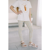 White t-shirt with peace sign, paired with good vibes lightweight leggings and sandals