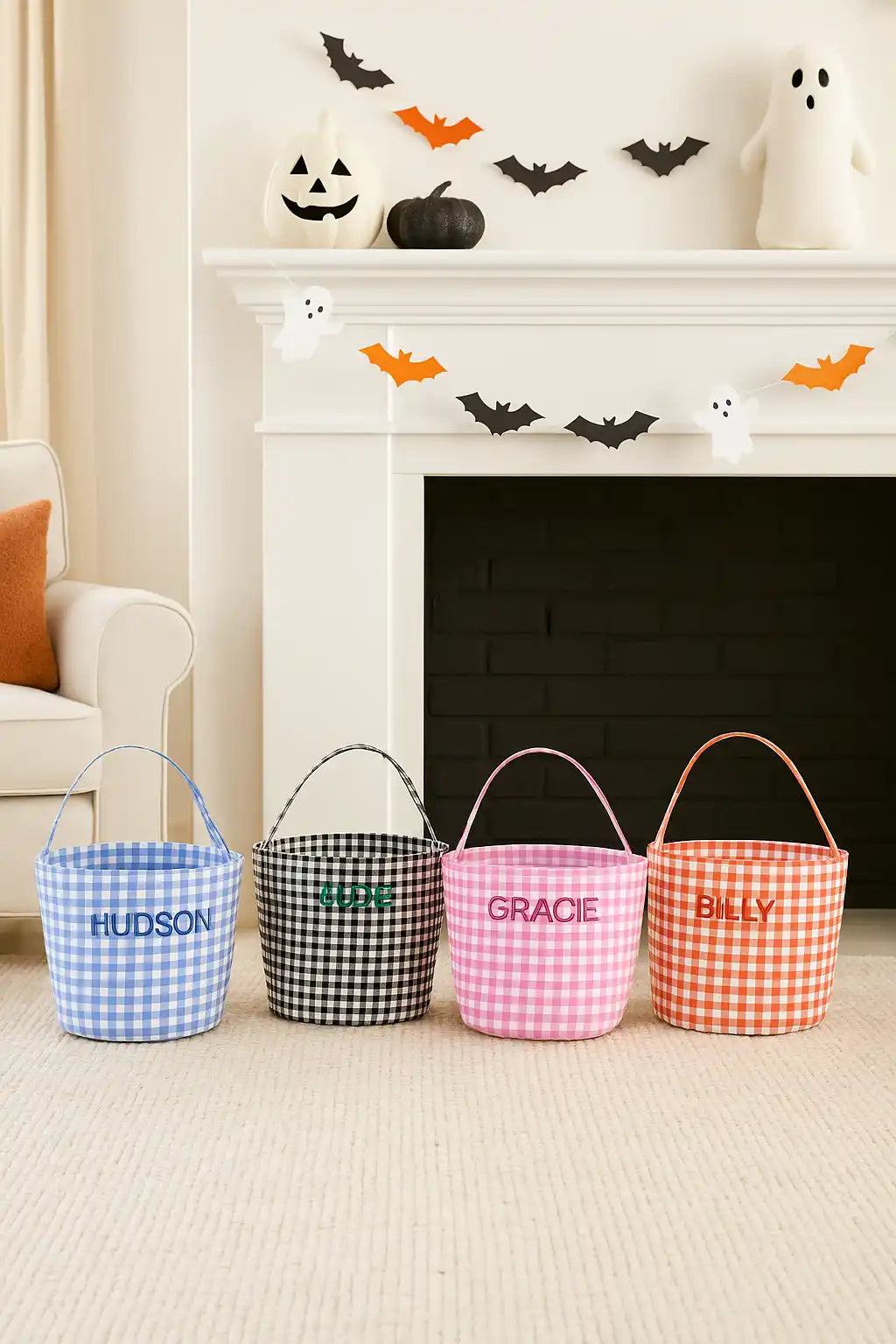Four personalized gingham Halloween treat pails.
