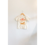 Child’s French Cafe Kids Graphic T-Shirt with croissant basket illustration and polished prints