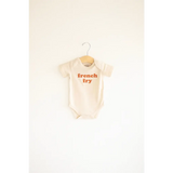 Cream-colored organic cotton baby onesie with french fry text, 3mo fits closer