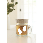 Clear glass mug with ghost decals, perfect for stylish womens clothes and polished prints