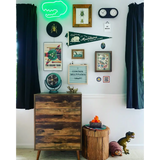 Wooden dresser with dark stained drawers and John Muir Home Pennant display