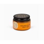 Jar of Golden Glow Beauty Balm for radiant skin, perfect with polished prints and stylish Womens clothes