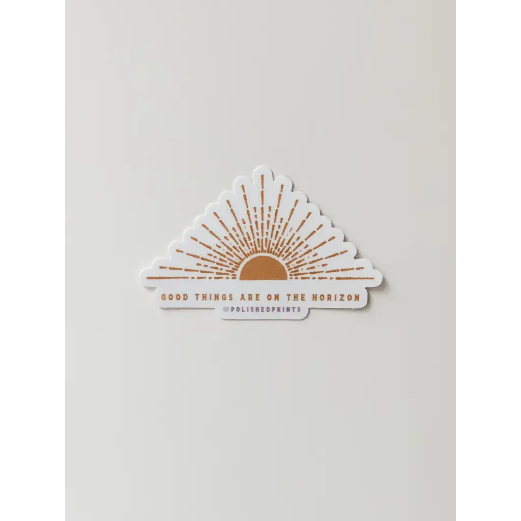 Decorative sticker with a rising sun and good things are on the horizon text