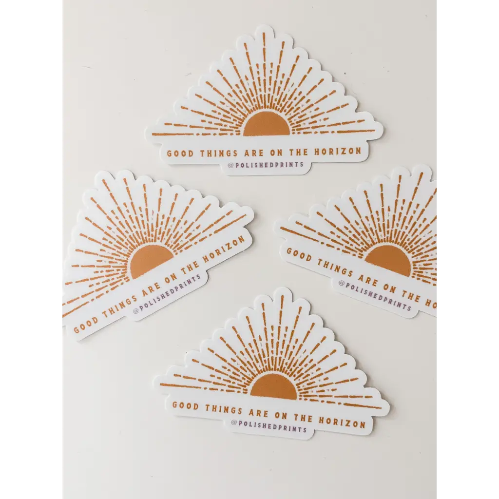 Four polished prints of Good Things are on the Horizon Stickers showcasing a rising sun design