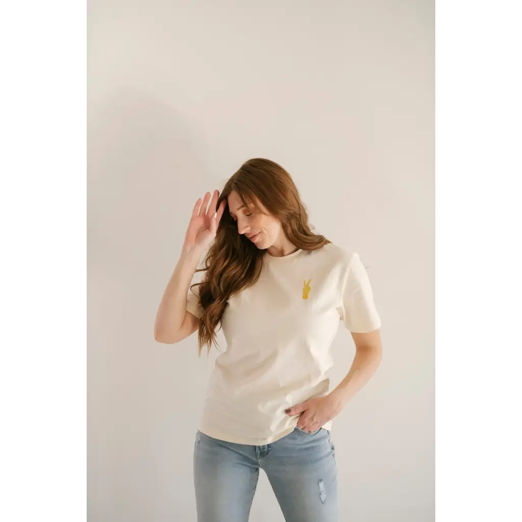 White Vibes Peace Embroidered Tee featuring a small yellow detail for good vibes peace