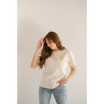 White Vibes Peace Embroidered Tee featuring a small yellow detail for good vibes peace
