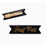 Black fabric patch with Half Pint in gold script on a cute Half Pint hair clip