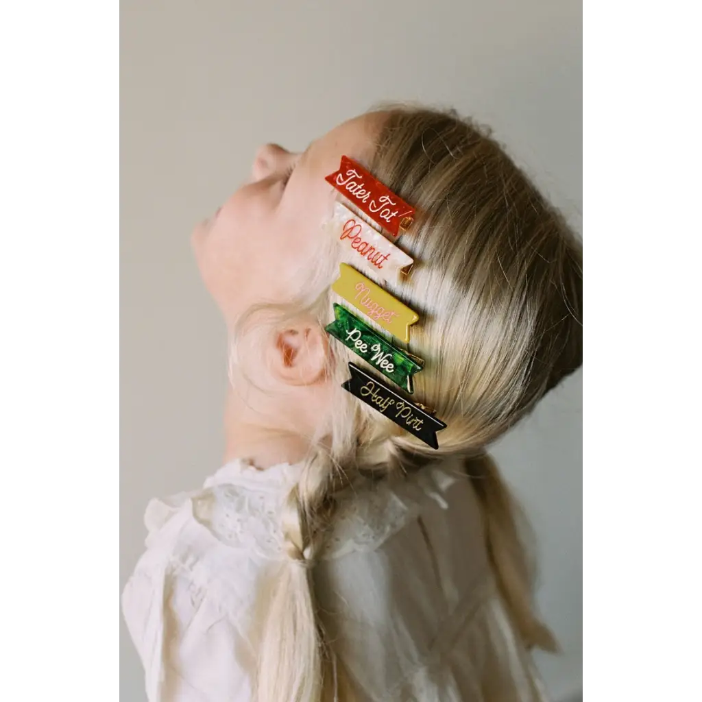 Colorful half pint hair clips on blonde hair for a cute and stylish look
