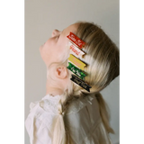 Colorful half pint hair clips on blonde hair for a cute and stylish look