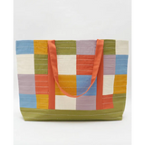 Colorful patchwork tote bag with orange straps and interior slip pocket for storage