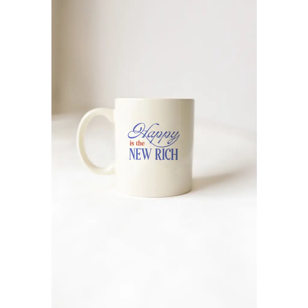 White mug with blue text from Happy Is The New Rich Mug showcasing polished prints