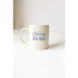 White mug with blue text from Happy Is The New Rich Mug showcasing polished prints
