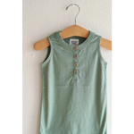 Mint green sleeveless henley romper on a wooden hanger, made of super soft organic cotton