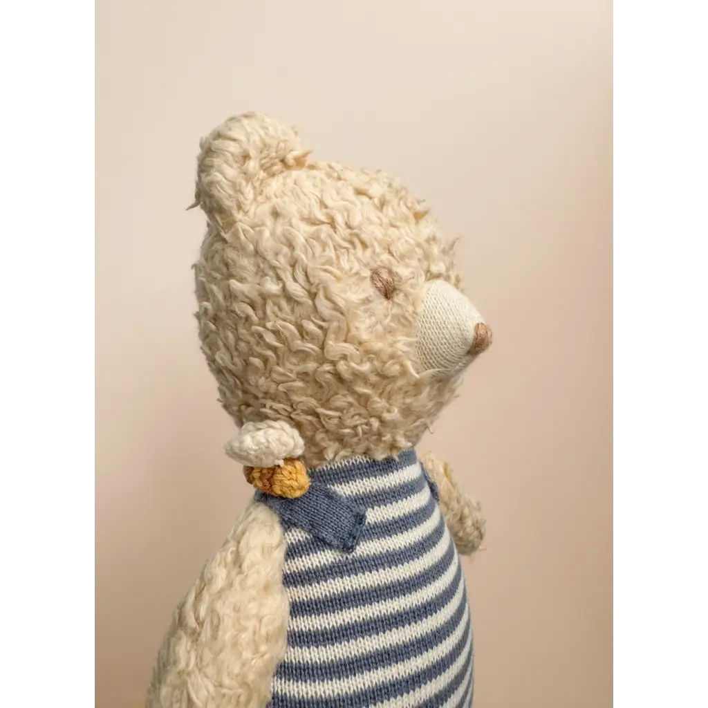 Cream-colored Henry Bear in a cozy blue and white striped sweater with a bow