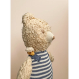 Cream-colored Henry Bear in a cozy blue and white striped sweater with a bow