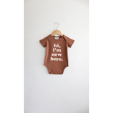 Brown Organic Cotton Baby Onesie with Hi, I’m New Here design for trendy little ones