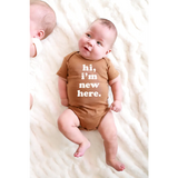 Brown Organic Cotton Baby Onesie featuring Hi, I’m New Here design for stylish newborns