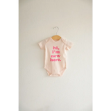 Cute Pink and White Organic Cotton Baby Onesie with Hi, I’m New Here Text