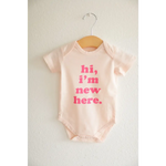 White Organic Cotton Baby Onesie with pink hi, I’m new here text, perfect for newborns