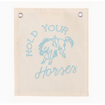 Light blue canvas banner featuring a bucking bronco design and text HOLD YOUR HORSES