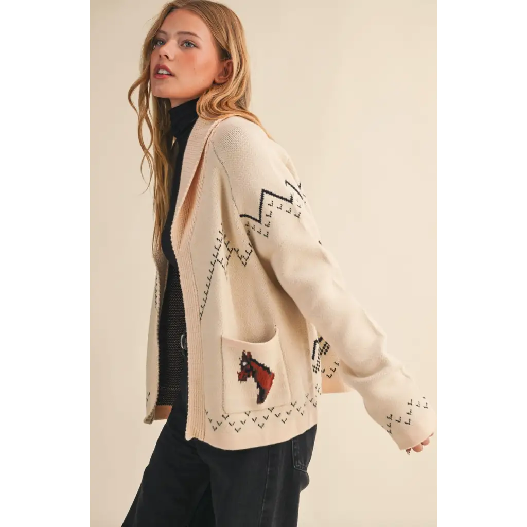 Cream-colored horse knit sweater cardigan with black zigzags and pixelated horse motif