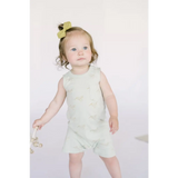 Toddler in mint green Hummingbird Pocket Playsuit with yellow hair bow, perfect one-piece
