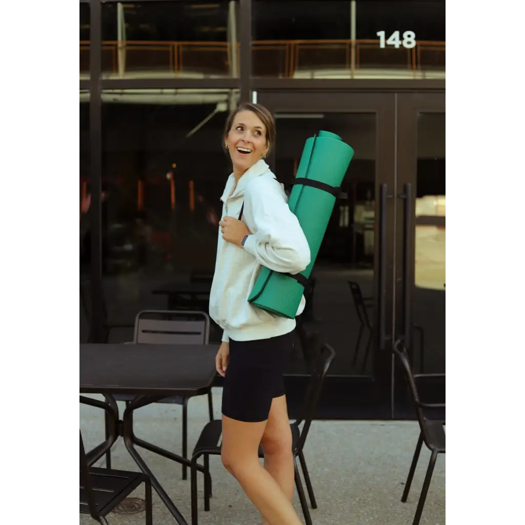 Someone with a bright green yoga mat on their back wearing a Kate Fleece Pullover