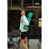 Someone with a bright green yoga mat on their back wearing a Kate Fleece Pullover