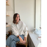 Person in a cream Kate Fleece Pullover and light blue jeans, perfect for every gal’s wardrobe