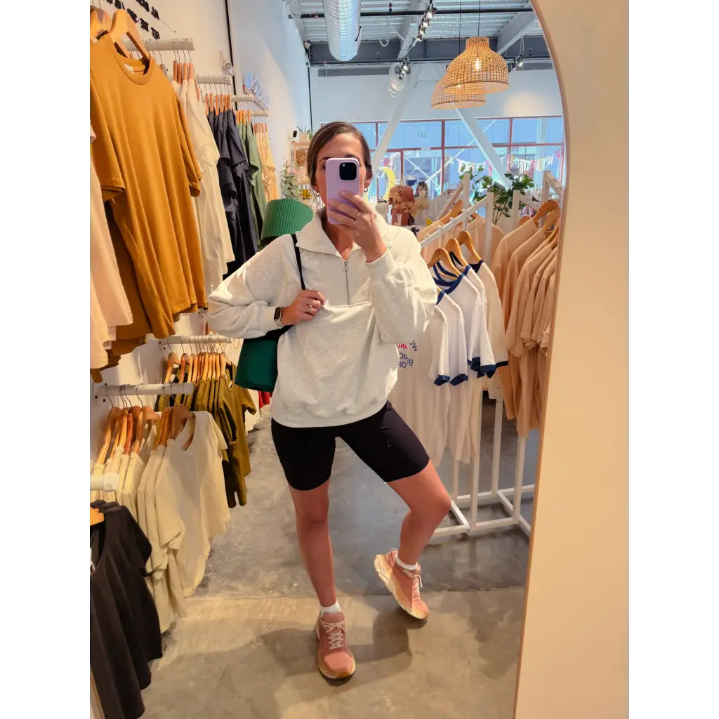 Casual look with Kate Fleece Pullover, black biker shorts, and tan sandals for every gal’s wardrobe
